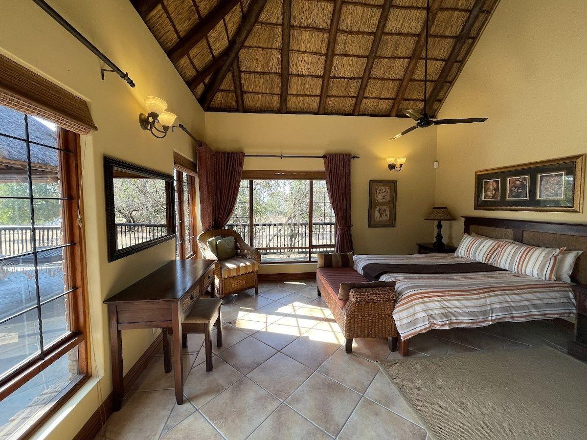 A main house bedroom with views over the deck