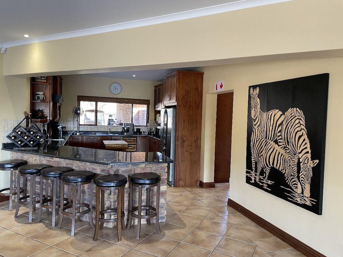 The kitchen, with its breakfast counter and bar stools